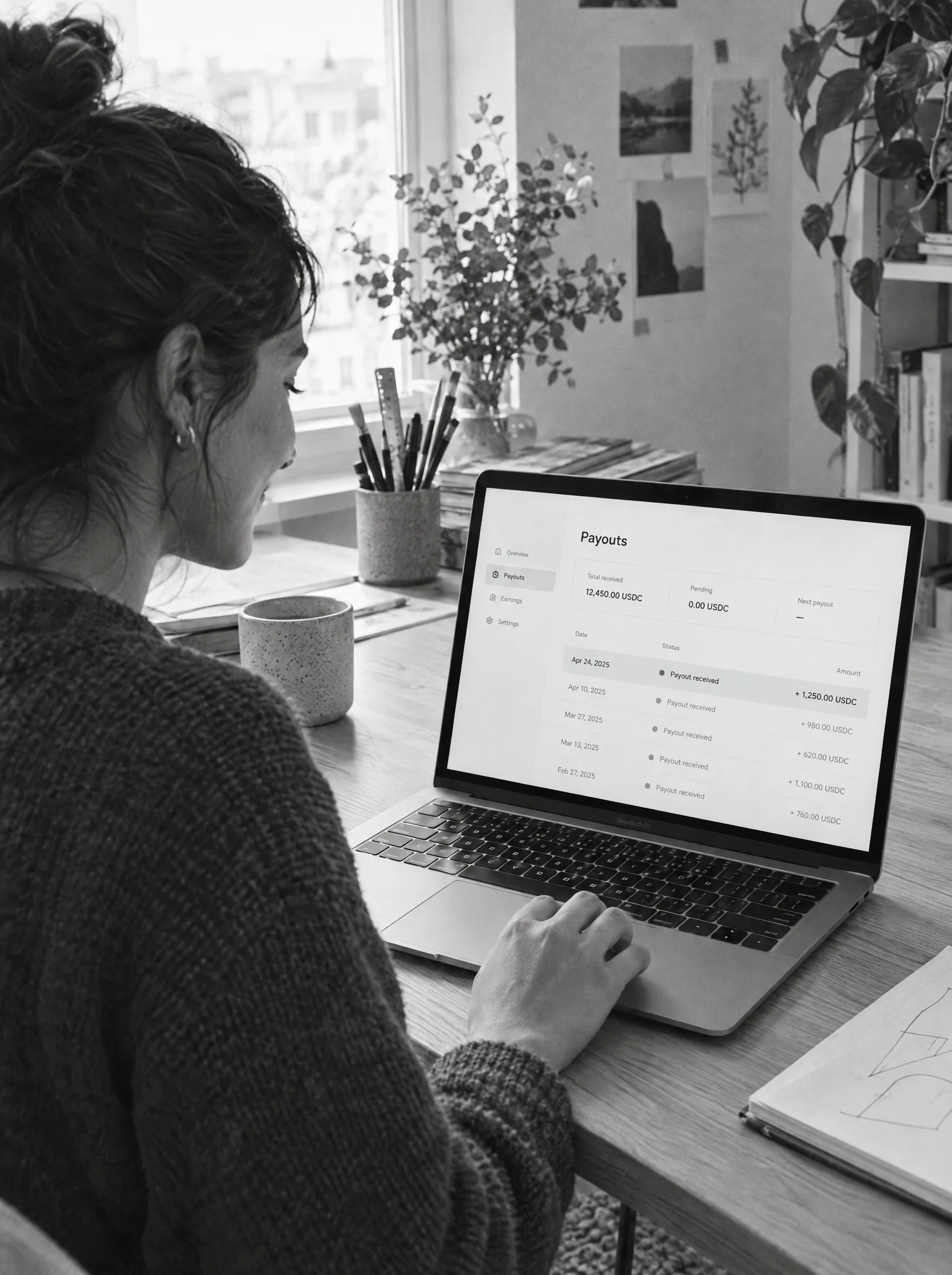 A freelancer looking at a payout on her laptop